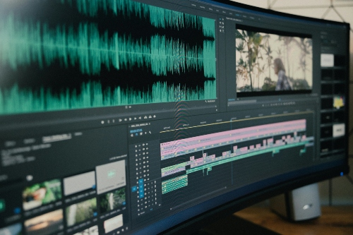 A monitor displaying a video editing software An ultrawide monitor displaying a video editing software in use